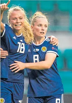  ??  ?? Kim Little, above, fires home her third – and Scotland’s fifth; Claire Emslie, left, celebrates her goal with Little. Pictures: SNS.