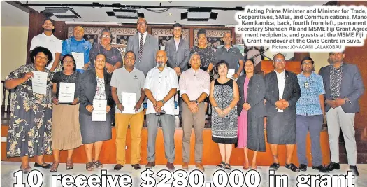  ?? Picture: JONACANI LALAKOBAU ?? Acting Prime Minister and Minister for Trade, Cooperativ­es, SMEs, and Communicat­ions, Manoa Kamikamica, back, fourth from left, permanent secretary Shaheen Ali and MSME Fiji Grant Agreement recipients, and guests at the MSME Fiji Grant handover at the Civic Centre in Suva.
