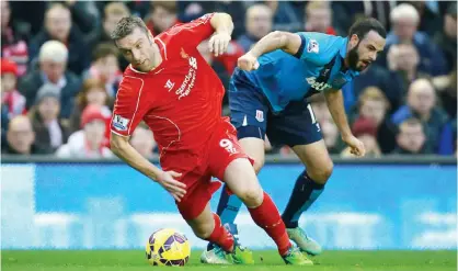  ??  ?? ANFIELD: Stoke City’s Marc Wilson (right) and Liverpool’s Rickie Lambert battle for the ball during the English Premier League soccer match at Anfield, Liverpool. — AP