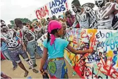  ?? ?? Raising awareness People paint at an event in Abidjan, Ivory Coast, to call attention to the Ebola virus affecting neighbouri­ng countries.
AFP
