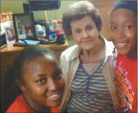  ??  ?? Cedartown High School Lady Builldogs players sit with a restident from Cedar Valley Nursing and Rehabilita­tion on Oct. 30 during the first of many Thursdays they’ll spend at the nursing home as part of a team Community Service project.