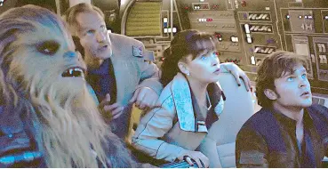  ??  ?? Space cowboy: Emilia Clarke, Woody Harrelson, Ehrenreich and Chewbacca take over the Millennium Falcon in Solo: A Star Wars Story.