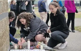  ?? ZACH LAING ?? Friends gather at a vigil for 45-year-old Fatos Metko and his 14-year-old son Fioralb Metko on Friday. They were killed in an Ontario crash last Sunday night, while the man’s wife and daughter were injured.