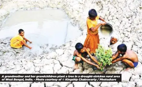  ?? ?? A grandmothe­r and her grandchild­ren plant a tree in a drought-stricken rural area of West Bengal, India. - Photo courtesy of © Kingship Chakravart­y / Photoshare