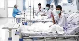  ?? ASSOCIATED PRESS ?? In this image made from video and released by the Thailand Government Spokesman Bureau, three of the 12 boys are seen recovering in their hospital beds after being rescued along with their coach from a flooded cave.