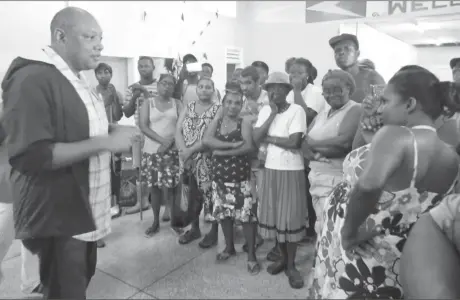  ??  ?? Minister of Natural Resources Raphael Trotman interacts with persons at the shelter set up at the Uitvlugt/Leonora Community Developmen­t Centre.