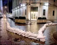  ?? AP/RICHARD DREW ?? Sandbags protect an entrance of the New York Stock Exchange