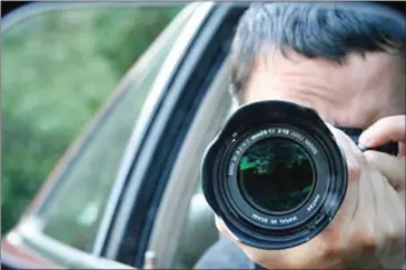  ?? SUPPLIED ?? A representa­tive image of a private investigat­or photograph­ing his subject from a car.
