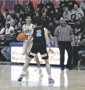  ?? PHOTO RUSSELL SOLIMINE ?? C.J. Spence looks over the Del Lago High defense in the CIF Division V boys’ championsh­ip game on Thursday, February 22nd, at Clairemont High in San Diego.