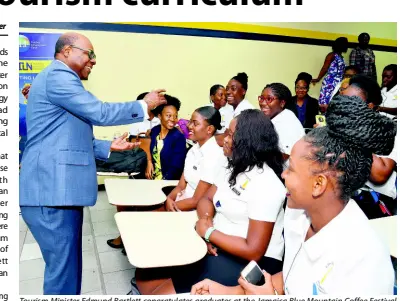  ??  ?? Tourism Minister Edmund Bartlett congratula­tes graduates at the Jamaica Blue Mountain Coffee Festival Volunteer Programme during the awards ceremony at the University of Technology, Jamaica, on Tuesday.