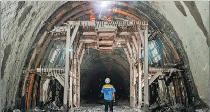  ?? PAN LONGZHU / XINHUA ?? Chinese workers build a railway tunnel in Laos. The railway, part of the Belt and Road Initiative, links the Laotian capital Vientiane to Boten, a town on the border with China.