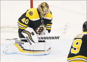  ?? John Minchillo / Associated Press ?? Bruins goaltender Tuukka Rask (40) makes a save during the third period against the Islanders on Saturday.