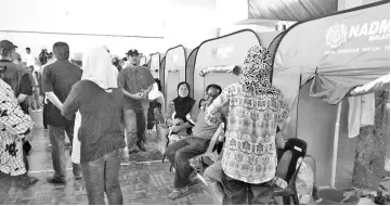  ??  ?? National Disaster Management Agency (Nadma) tents for the fire victims in the Putatan mini hall.