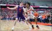  ?? AP PHOTO/ADRIAN KRAUS ?? Syracuse forward Chris Bell (4) is defended by Clemson guard Joseph Girard III (11) during the second half of an NCAA college basketball game in Syracuse, N.Y., Saturday, Feb. 10, 2024.