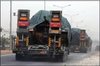  ?? AP/ERSIN ERCAN ?? A Turkish forces convoy of trucks carrying tanks destined for Syria travels near the town of Reyhanli, Turkey, on Thursday.