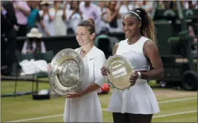  ?? TIM IRELAND - THE ASSOCIATED PRESS ?? Winner Simona Halep, left, and second placed Serena Williams pose with their trophies after the women’s singles final match on day twelve of the Wimbledon Tennis Championsh­ips in London on Saturday.