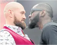  ??  ?? Tyson Fury, left, and Deontay Wilder face off during a news conference in New York last month.