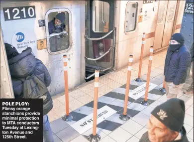  ?? ?? POLE PLOY: Flimsy orange stanchions provide minimal protection to MTA conductors Tuesday at Lexington Avenue and 125th Street.