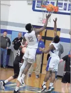  ?? Barbara Hall ?? Gordon Central senior forward Scott James sails high over teammate Omar Byrd for a rebound against Southeast Whitfield County.