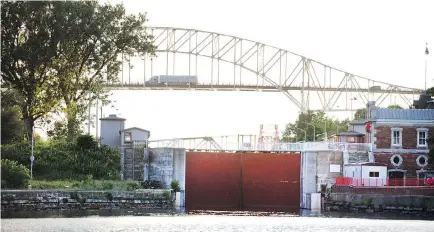  ?? PETER J. THOMPSON / NATIONAL POST ?? The Canadian Sault Lock in the foreground as a transport truck makes its way over the Sault Ste. Marie Internatio­nal Bridge. The small twin border cities of Sault Ste. Marie, in Ontario and Michigan, are bidding for Amazon’s second headquarte­rs.