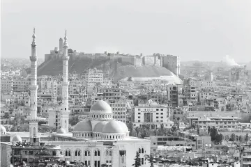  ??  ?? File photo shows smoke rising near Aleppo citadel after air strikes in Aleppo city, Syria. — Reuters photo