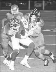  ?? Special to NWA Democrat-Gazette/MARK STALLINGS ?? Greenwood’s Aaron Ohl (left) and Dawson James (right) stop Jason Bradley of Sylvan Hills after a short gain Friday at Smith-Robinson Stadium in Greenwood.