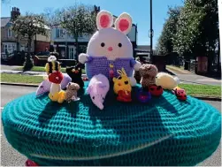  ??  ?? Easter funny: Bunny and pals on a Sheffield post box and, right, Rosalynn Austin enjoys a rainbow hat in Portsmouth