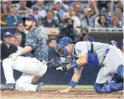  ??  ?? San Diego Padres’ Cory Spangenber­g, left, reacts to the umpire’s out call at home plate against the Dodgers Wednesday. The Padres have yet to score in 2016.