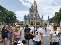  ?? JOEBURBANK—ORLANDOSEN­TINELVIAAP ?? Guests wear masks as required at Saturday’s official reopening day of the Magic Kingdom at Walt Disney World in Lake Buena Vista, Fla.