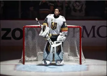  ?? Gene J. Puskar The Associated Press ?? Vegas Golden Knights goaltender Marc-Andre Fleury stands during the national anthem before a Feb. 6 game against his former team, the Pittsburgh Penguins. It was his first game in Pittsburgh as a Golden Knight. The Penguins won 5-4.