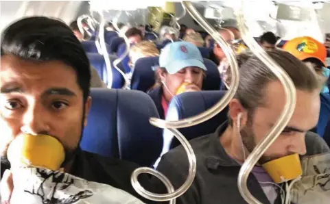  ??  ?? Terror: The window, left, shattered by shrapnel from the exploded engine. Above: Emergency oxygen masks were deployed as the Boeing 737 plummeted