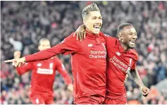  ?? - AFP photo ?? Liverpool’s Guinean midfielder Naby Keita (R) celebrates with Liverpool’s Brazilian midfielder Roberto Firmino after scoring a goal during the UEFA Champions League quarter-final, first leg football match.