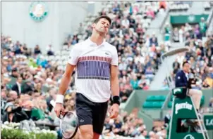  ?? THOMAS SAMSON/AFP ?? Novak Djokovic reacts during his tennis match against Dominic Thiem at the 2017 French Open at Roland Garros in Paris on Wednesday.