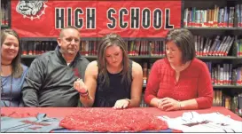  ??  ?? Top: Ava Tillmann waits with her family to make a grand entrance into her signing. Top right: Family, friends and teammates gathered for the event. Above right: Jessica Sanders talks about seeing Tillmann play. Left: With a stroke of a pen, Tillmann...