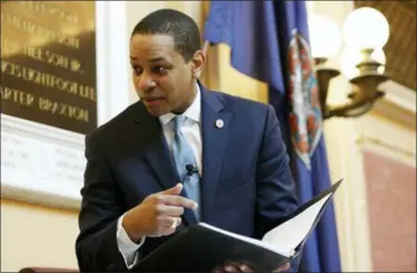  ?? STEVE HELBER — THE ASSOCIATED PRESS ?? Virginia Lt. Gov Justin Fairfax looks over a briefing book prior to the start of the senate session at the Capitol in Richmond, Va., Thursday.