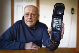  ?? ROBERT F. BUKATY / ASSOCIATED PRESS 2016 ?? Peter Froehlich holds a landline telephone he uses at his rural home in Whitefield, Maine. According to a U.S. government study, just 45.9 percent of households in this country still had landlines in the latter half of 2016. Cellphones suit many...