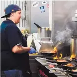  ??  ?? Award-winning chef Marie Yniguez cooks up a storm at Slow Roasted Bocadillos restaurant, which she co-owns with her wife.