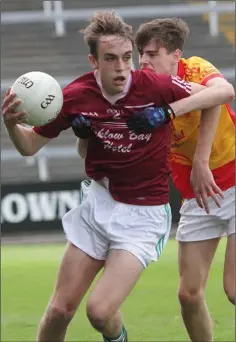  ??  ?? Ross Coady of Castle-Craan Gaels is tackled by Andrew Harrington.