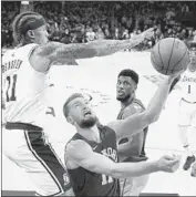  ?? Mark J. Terrill Associated Press ?? MICHAEL BEASLEY goes for the block on Indiana’s Domantas Sabonis during Thursday’s game.