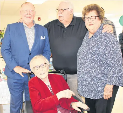  ?? KATHERINE HUNT/THE GUARDIAN ?? Helen Stetson, seated, celebrated her 100th birthday with family and friends at the Atlantic Baptist Home on Sunday. Shown with Stetson are, from left, sons and daughter Kent Stetson, Paul Stetson and Elizabeth Rowe.