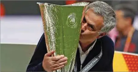  ??  ?? Jose Mourinho kisses the Europa trophy shortly after Manchester United defeated Ajax 2-0 in Stockholm… on Wednesday night