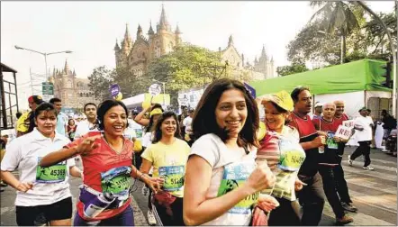  ??  ?? Participan­ts pass the Chhatrapat­i Shivaji Terminus during the Standard Chartered Mumbai Marathon yesterday. More than 39,000 people took part in the run.