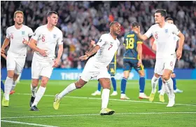  ?? Picture: Getty. ?? Raheem Sterling wheels away followed by team-mates after scoring for England against Kosovo.