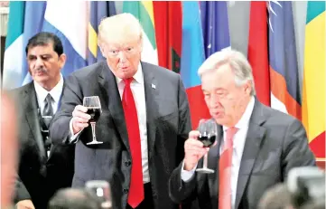  ??  ?? Trump raises his glass in a toast alongside United Nations Secretary-General Antonio Guterres during a luncheon for world leaders during the 73rd session of the United Nations General Assembly in New York, US. — Reuters photo