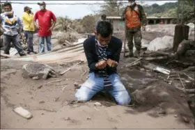  ?? MOISÉS CASTILLO — THE ASSOCIATED PRESS ?? Bryan Rivera cries Thursday while looking at the remains of his house after his family went missing during the Volcan de Fuego or “Volcano of Fire” eruption, in San Miguel Los Lotes, Guatemala.