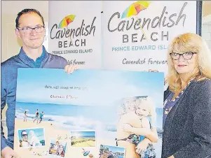  ?? MITCH MACDONALD/THE GUARDIAN ?? Kevin Champion of Tourism Cavendish Beach and president Sandi Lowther hold up one of the promotiona­l posters for the group’s 2017 marketing plan that was unveiled during the group’s spring general meeting Tuesday night. The group is aiming to...