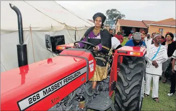  ?? Picture: TYLER RIDDIN ?? POWER TO FARMING: Nothembile Dlulane, founder of the Mtsekane Farming Cooperativ­e in Centane, sits on the Massey Ferguson tractor that was donated by Mnquma municipali­ty