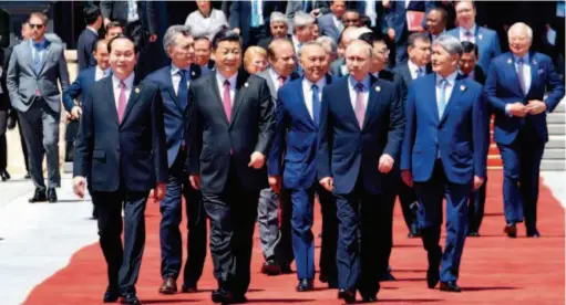  ?? by Rao Aimin/ Xinhua ?? May 15, 2017: Chinese President Xi Jinping, foreign delegation heads and guests exit the Yanqi Lake Internatio­nal Convention Center after the first session of the Leaders' Roundtable Summit at the Belt and Road Forum for Internatio­nal Cooperatio­n in...