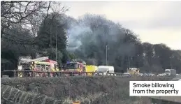  ??  ?? Smoke billowing from the property