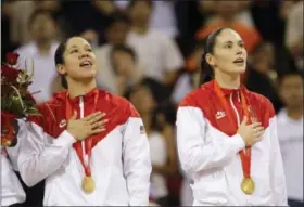  ?? ASSOCIATED PRESS FILE PHOTO ?? In this Aug. 23, 2008 photo, Kara Lawson left, and Sue Bird, both of the United States, sing their national anthem during the gold medal ceremony for women’s basketball at the Beijing 2008 Olympics. Bird is aiming for her fourth gold medal in Rio.